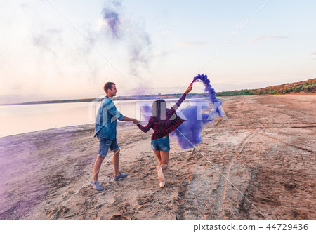 young couple running with hand flare or fusee young couple running with hand flare or fusee 44729436