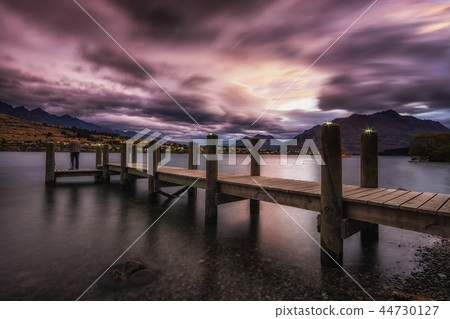 sunset with a dock in lake wakatipu 44730127