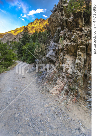 Rock wall and mountains in the background Rock wall and mountains in the background 44730980