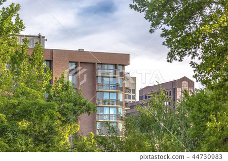 Residential high rise with puffy clouds Residential high rise with puffy clouds 44730983