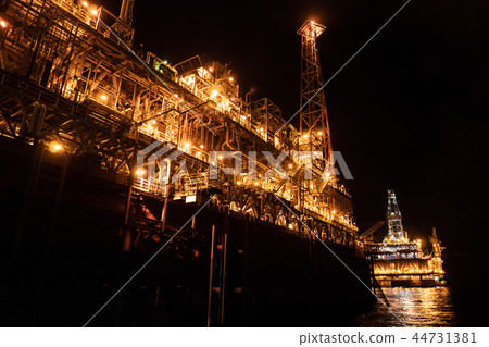 FPSO tanker vessel near Oil platform Rig at night. Offshore oil and gas industry 44731381