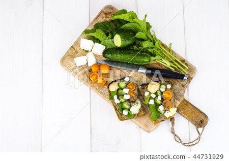 Fresh vegetables and leaves of arugula for sandwiches Fresh vegetables and leaves of arugula for sandwiches 44731929