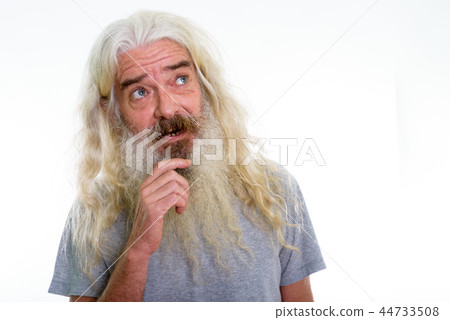 Close up of happy senior bearded man smiling while thinking and Close up of happy senior bearded man smiling while thinking and 44733508