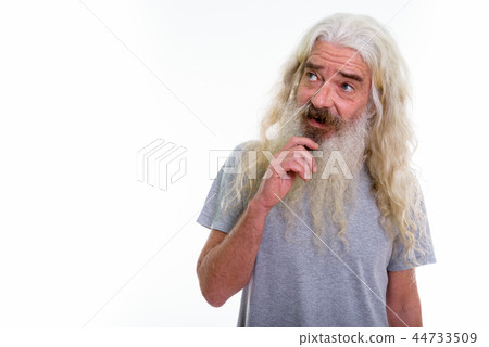 Studio shot of happy senior bearded man smiling while thinking a Studio shot of happy senior bearded man smiling while thinking a 44733509