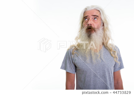 Studio shot of senior bearded man thinking while looking up 44733829