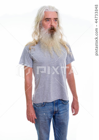 Studio shot of senior bearded man standing and thinking while lo 44733848