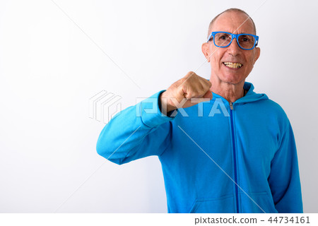 Studio shot of happy bald senior man smiling while wearing eyegl Studio shot of happy bald senior man smiling while wearing eyegl 44734161