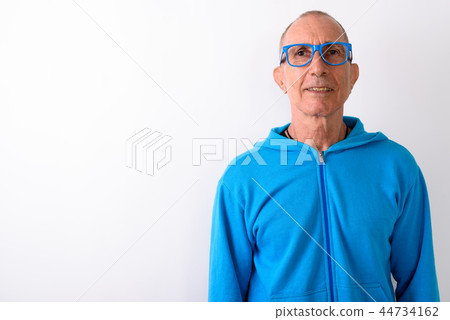 Studio shot of happy bald senior man smiling while wearing eyegl Studio shot of happy bald senior man smiling while wearing eyegl 44734162