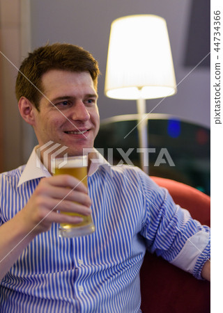 Young handsome businessman relaxing at the hotel lobby 44734366