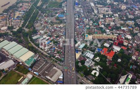 Cars driving on bridge roads with buildings. Aerial view of Expr Cars driving on bridge roads with buildings. Aerial view of Expr 44735789