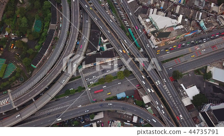 Cars driving on bridge roads shaped curve highways with skyscrap Cars driving on bridge roads shaped curve highways with skyscrap 44735791
