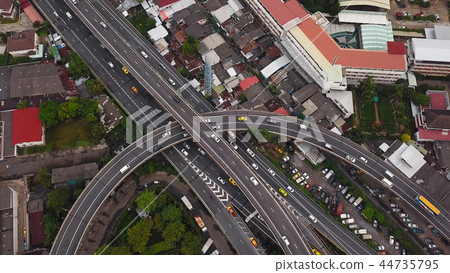 Cars driving on bridge roads shaped curve highways with skyscrap 44735795