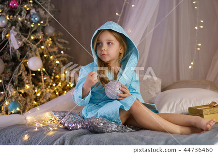 Little girl in bathrobe. Christmas Little girl in bathrobe. Christmas 44736460