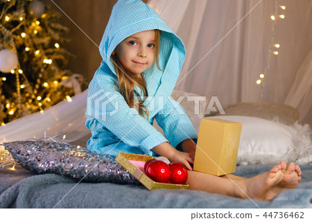 Little girl in bathrobe. Christmas Little girl in bathrobe. Christmas 44736462
