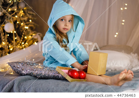 Little girl in bathrobe. Christmas Little girl in bathrobe. Christmas 44736463