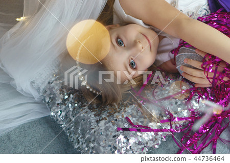 Little girl celebrates Christmas at home Little girl celebrates Christmas at home 44736464