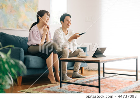 Young Japanese Couple Watching TV in Room 44737098