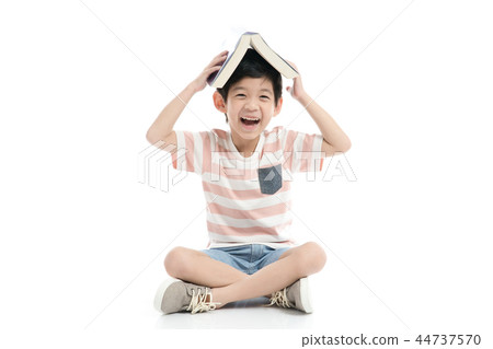 Cute Asian boy with book on head Cute Asian boy with book on head 44737570