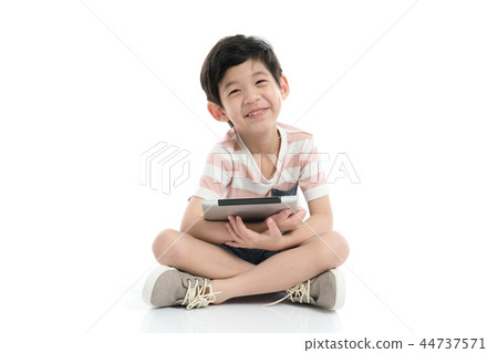 Cute Asian child with a tablet sitting Cute Asian child with a tablet sitting 44737571