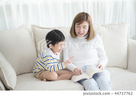 Asian mother Sitting With Son Reading Story Asian mother Sitting With Son Reading Story 44737762