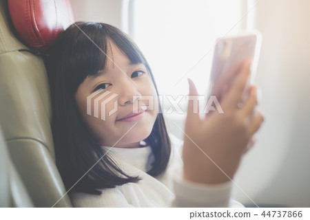 Asian girl use of mobile phone Asian girl use of mobile phone 44737866