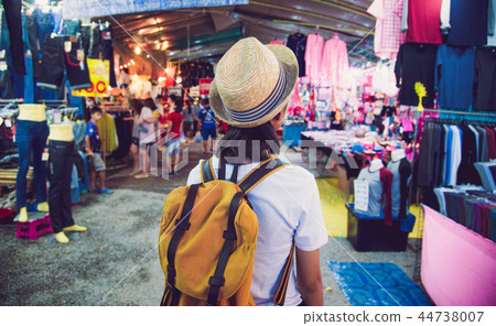 Teenagers backpacking along the market Teenagers backpacking along the market 44738007