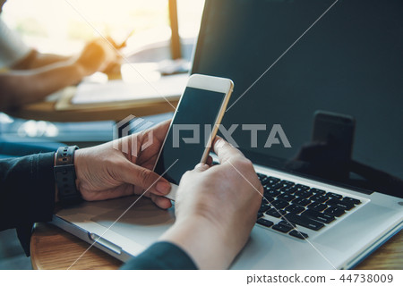 Businessmen use smartphones and laptop Businessmen use smartphones and laptop 44738009