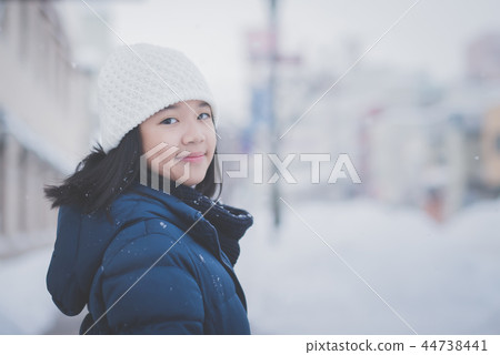 Asian girl enjoying snowfall Asian girl enjoying snowfall 44738441