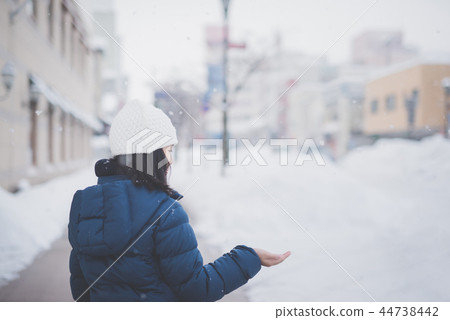 Asian girl enjoying snowfall Asian girl enjoying snowfall 44738442