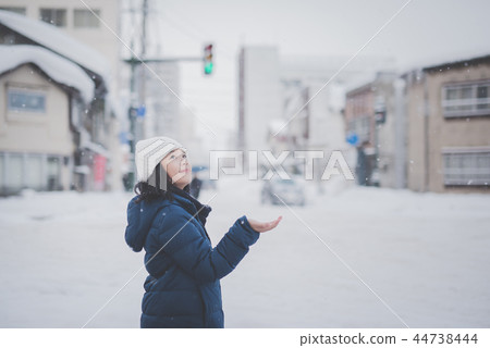 Asian girl enjoying snowfall Asian girl enjoying snowfall 44738444