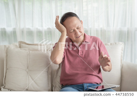 Asian old man at home having a headache Asian old man at home having a headache 44738550