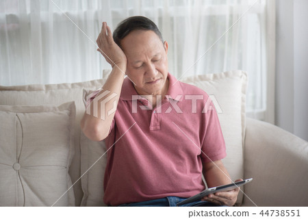 Asian old man at home having a headache Asian old man at home having a headache 44738551