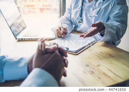 The doctor is discussing with the patient The doctor is discussing with the patient 44741850