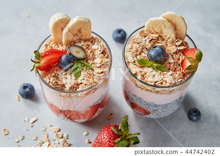 Dietary natural breakfast with natural organic ingredients - strawberries, granola, banana in a Dietary natural breakfast with natural organic ingredients - strawberries, granola, banana in a 44742402