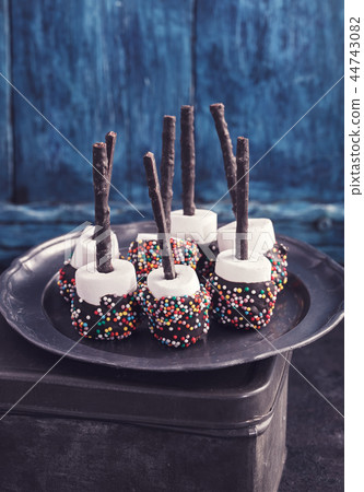 Chocolate covered marshmallows on blue Chocolate covered marshmallows on blue 44743082