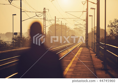 Man waiting at railroad station 44745960