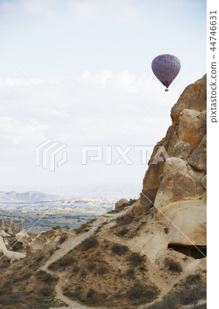 Hot air balloon flying over the rocky land Hot air balloon flying over the rocky land 44746631