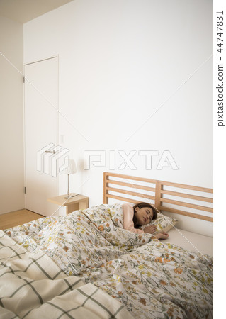 A young woman sleeping in bed 44747831