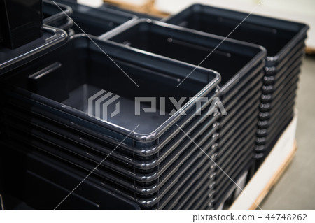 black plastic containers stack in a store black plastic containers stack in a store 44748262