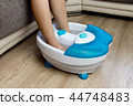 Feet in a vibrating foot massager. massage bath 44748483