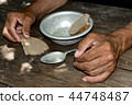 Hands the poor old man's, piece of bread  44748487