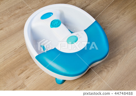 Feet in a vibrating foot massager.massage bath. Feet in a vibrating foot massager.massage bath. 44748488