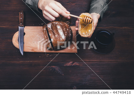 Top view female hands make sandwich of rye bread 44749418