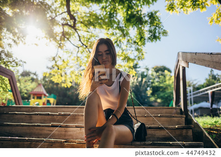 Young woman wearing shorts and white top Young woman wearing shorts and white top 44749432