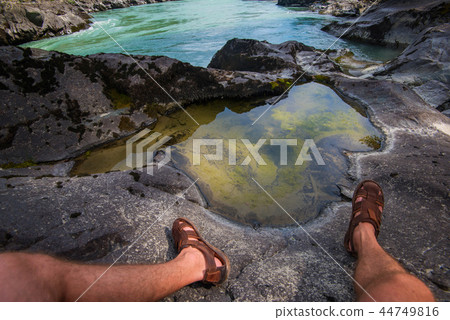 Man standing on top of cliff Man standing on top of cliff 44749816
