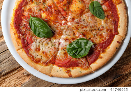 Pizza margherita with leaves of fresh basil 44749925