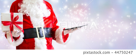 Santa holding a tablet computer 44750247