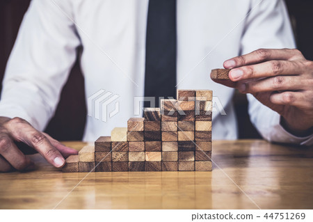Risk To Make Business Growth Concept With Wooden Blocks, hand of 44751269