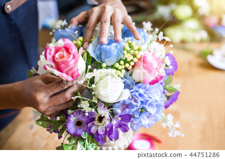Arranging artificial flowers vest decoration at home, Young woma 44751286