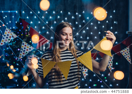 Girl decorating home Christmas New Year time Girl decorating home Christmas New Year time 44751888